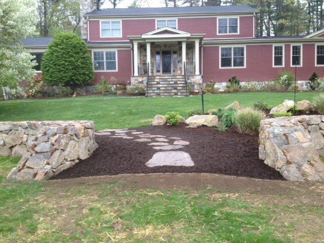 Stone entrance walls and a stepping path at a Fairfield County home