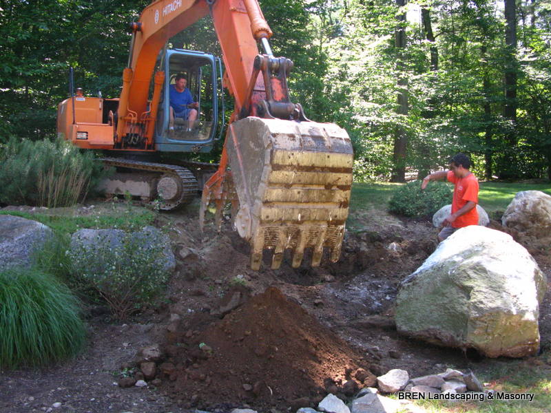 Boulders being set on a BREN Landscaping job site